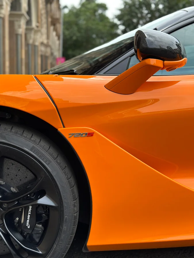 Close detail of an orange McLaren sports car